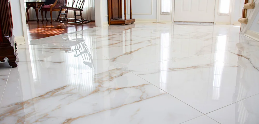 Modern living room featuring light oak-look luxury vinyl plank flooring and contemporary furniture with floor-to-ceiling windows.